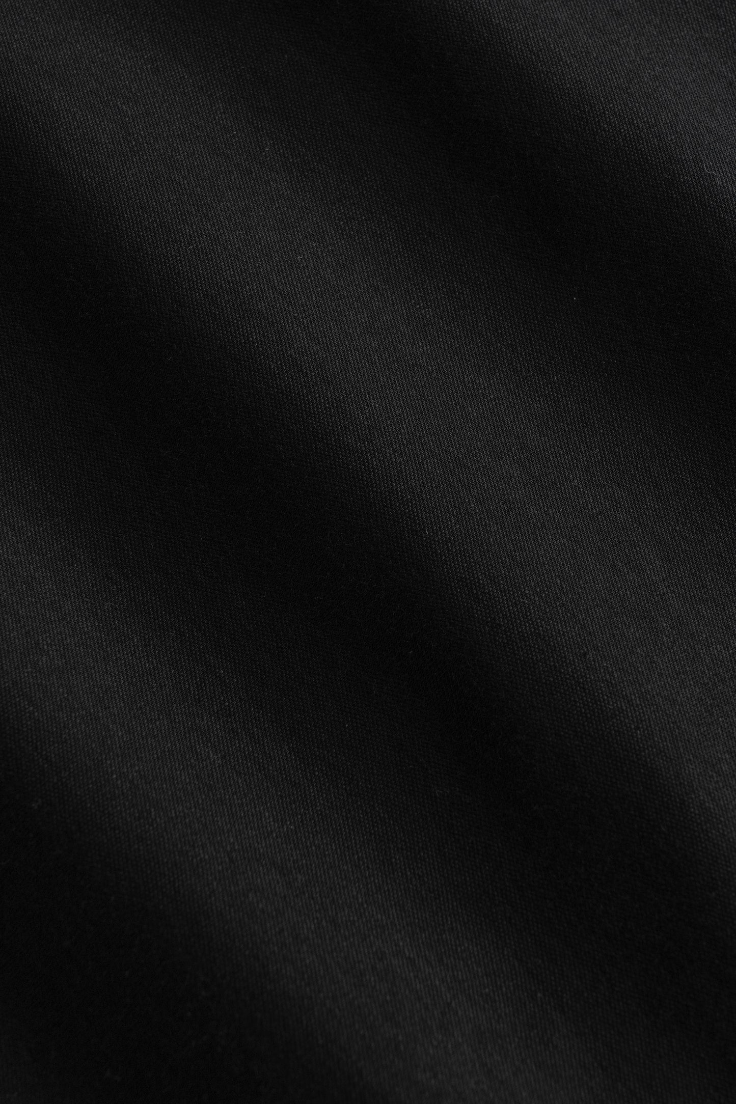 Black herringbone knit polo shirt with textured fabric detail.