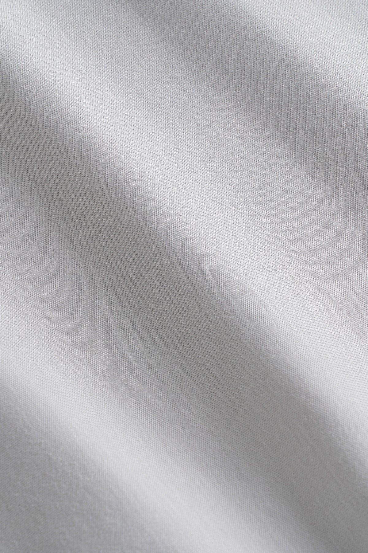Light gray ribbed cotton fabric with soft folds and draping texture.