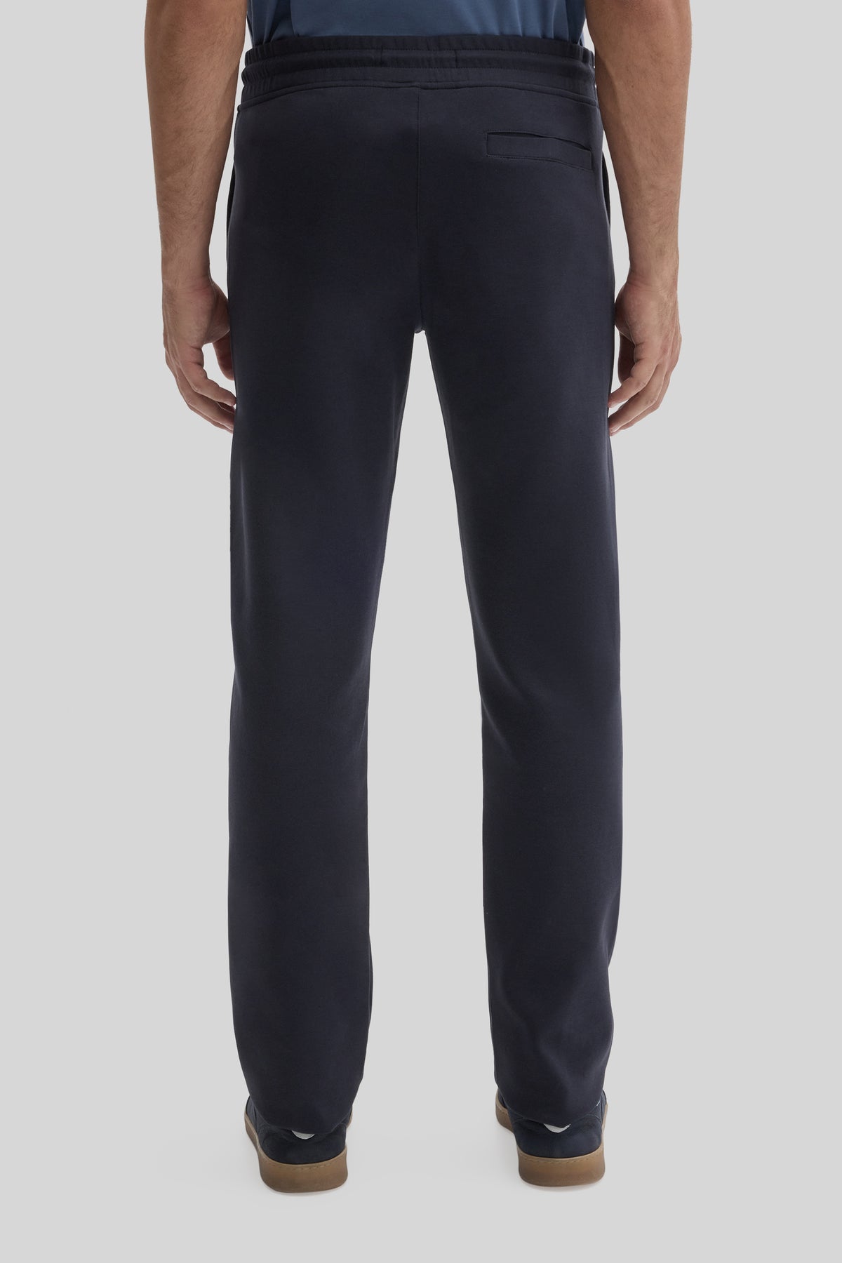 Black jogging pants with drawstring waist, back pocket, and cuffed ankles with tan trim.