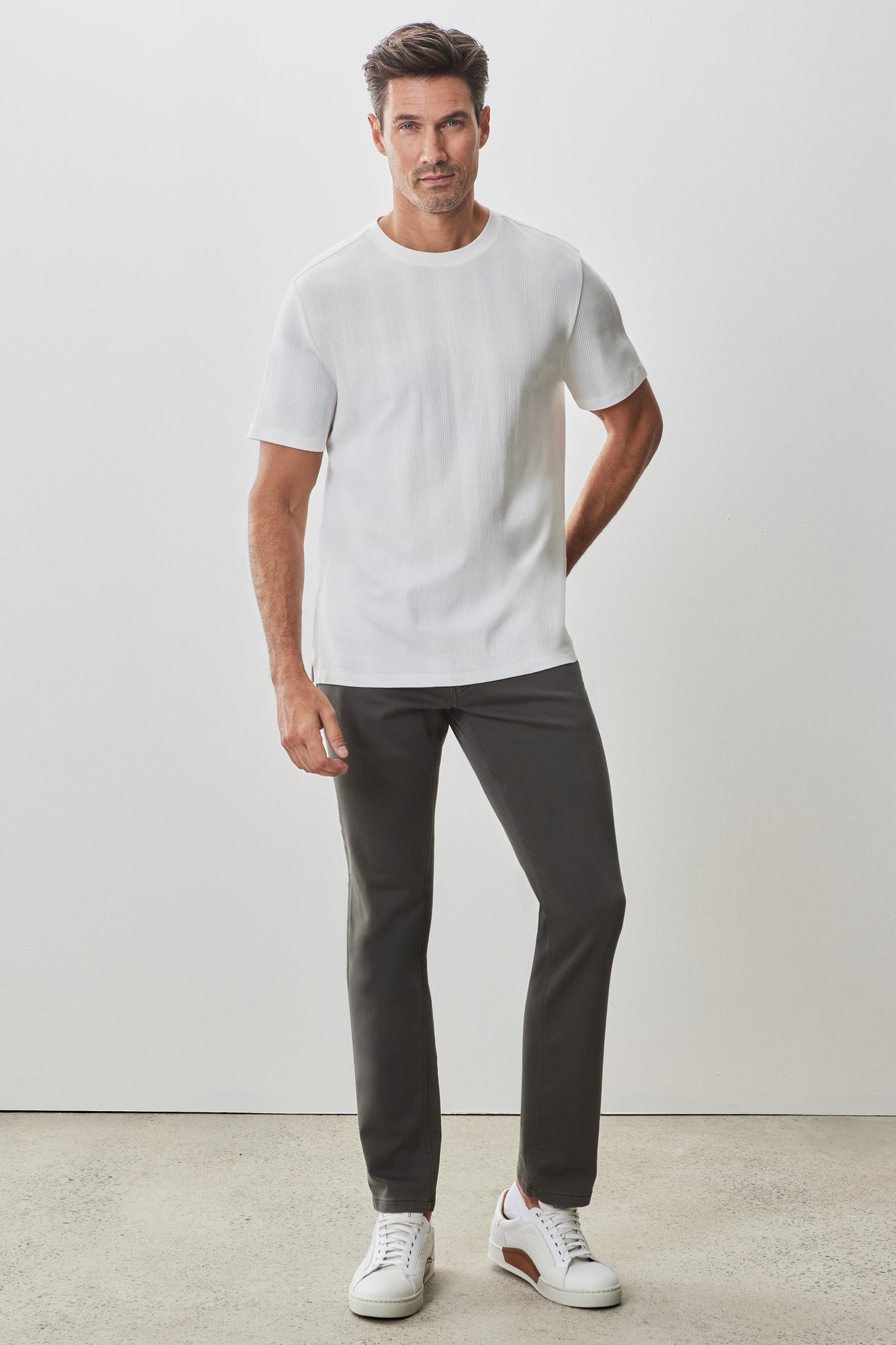 Men's white textured short-sleeve crew neck tee with visible ribbed fabric detail.