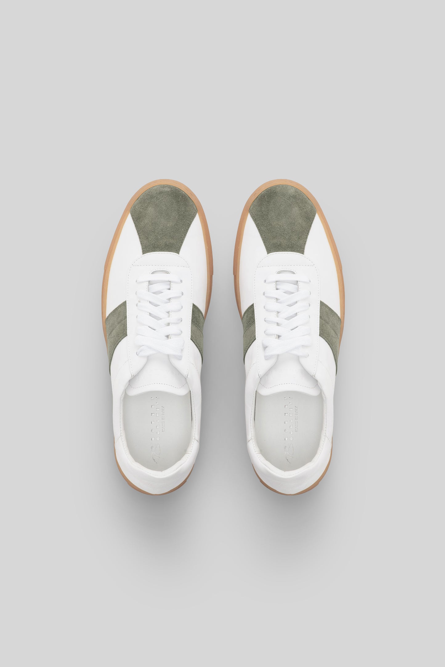 White sneakers with olive green stripes and gum sole, shown from above.