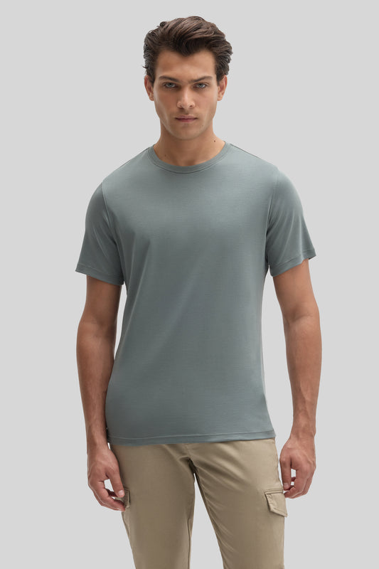 Man wearing sage green crew-neck t-shirt with short sleeves and khaki cargo pants.