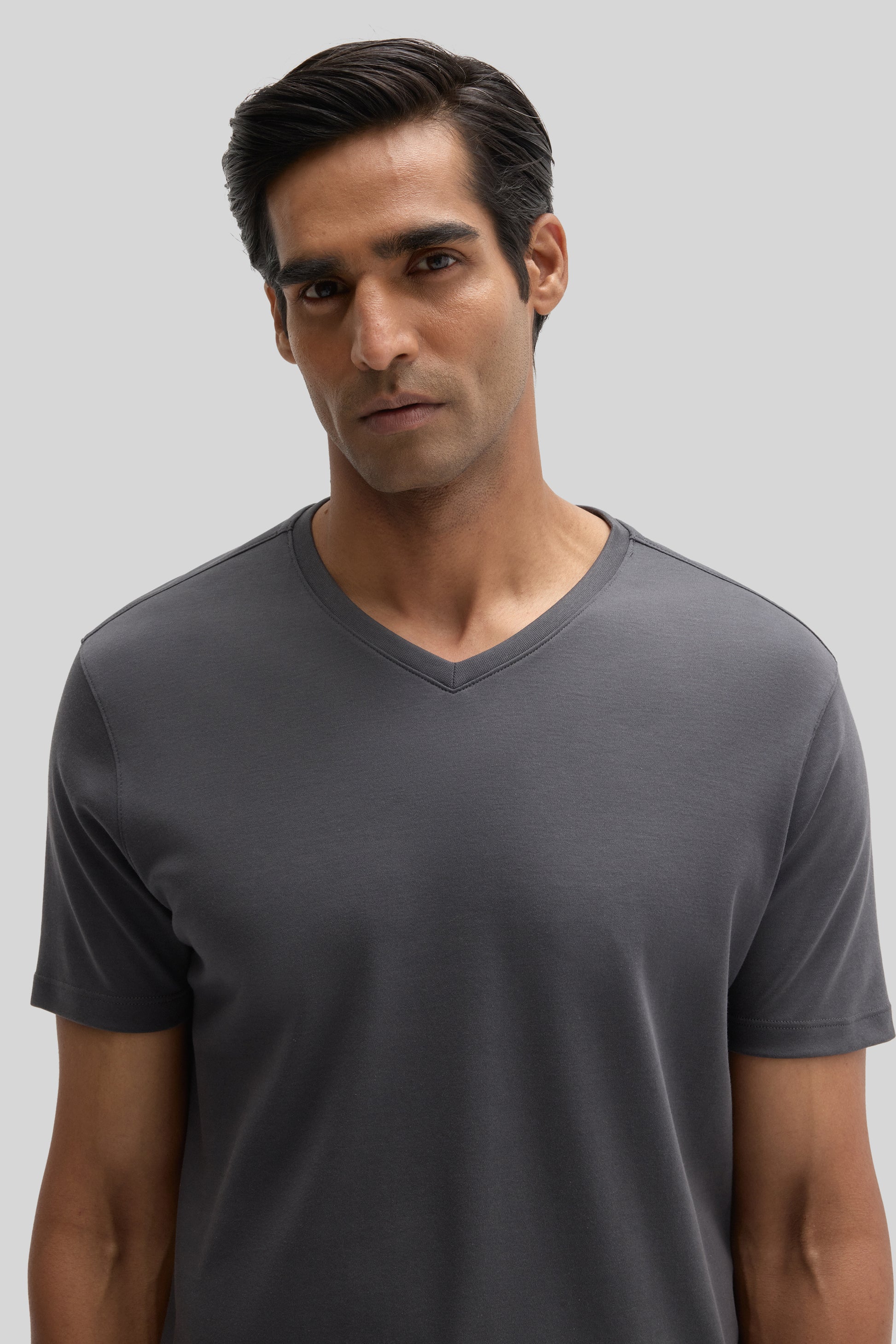 Man wearing a charcoal gray V-neck short-sleeve t-shirt.