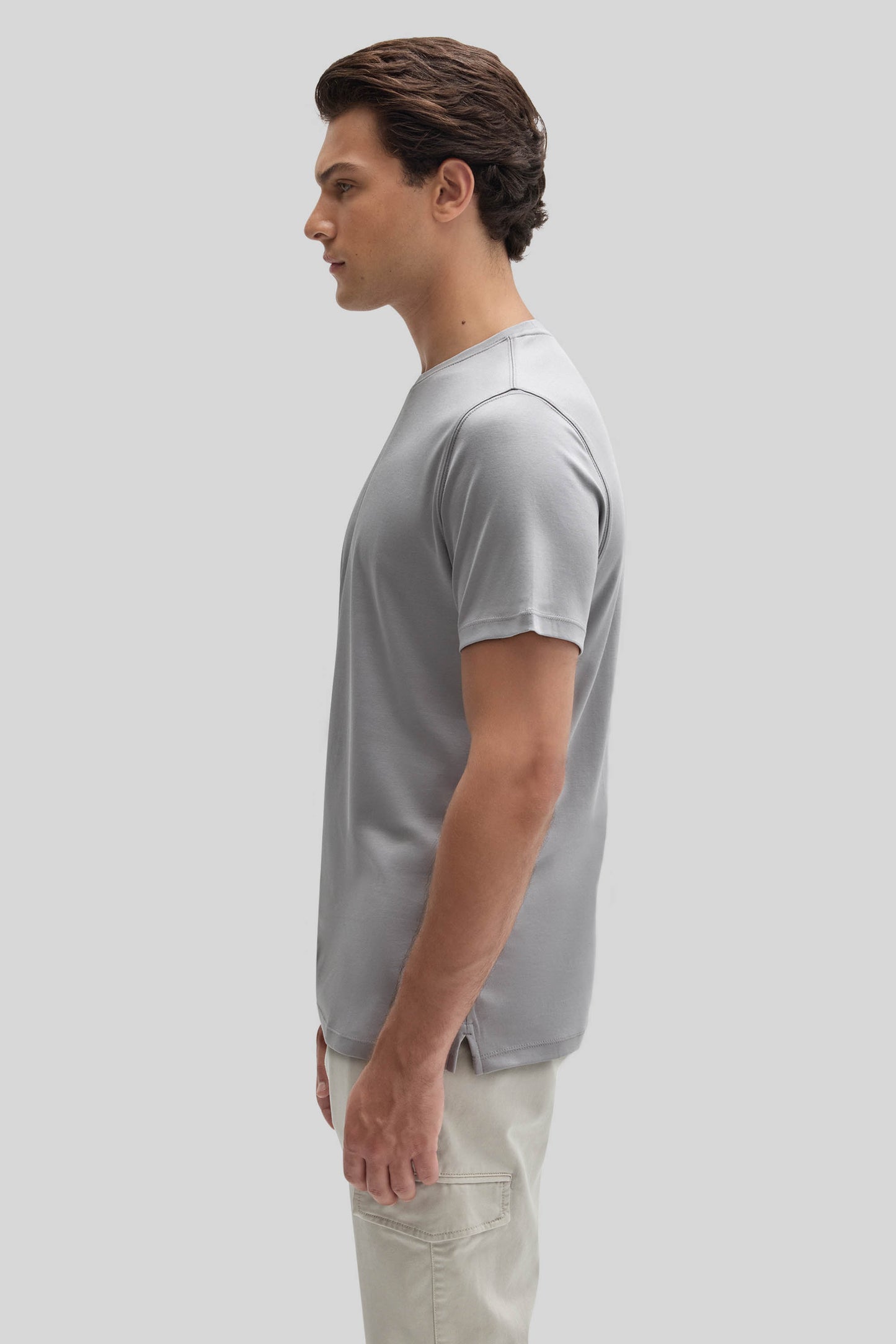 Man wearing light gray short-sleeve t-shirt with crew neckline, shown in profile view.