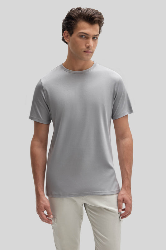 Man wearing light gray crew neck t-shirt with short sleeves and cream-colored pants.