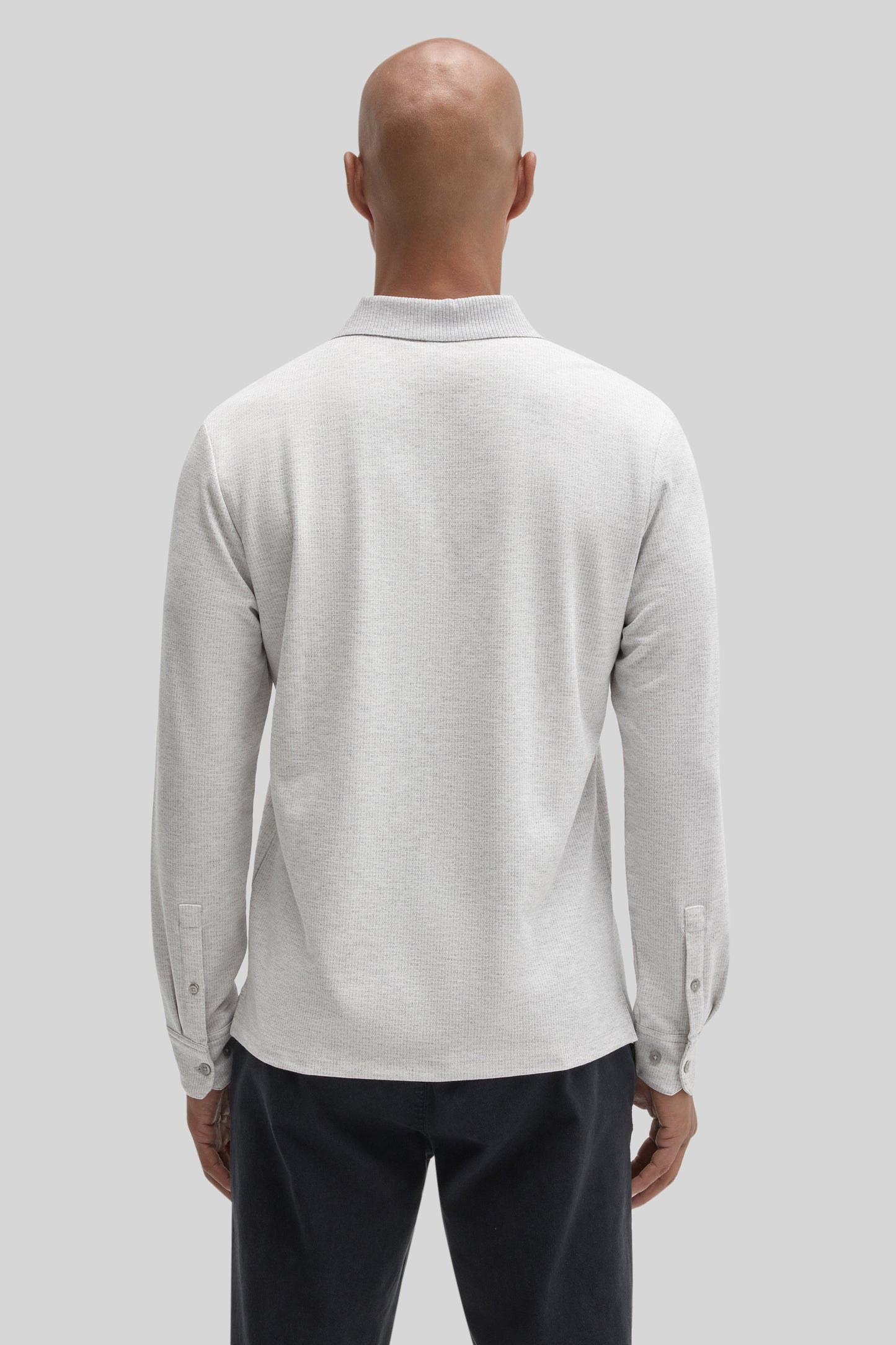 Light gray long-sleeve polo shirt with ribbed collar and button cuffs, shown from back view on model.
