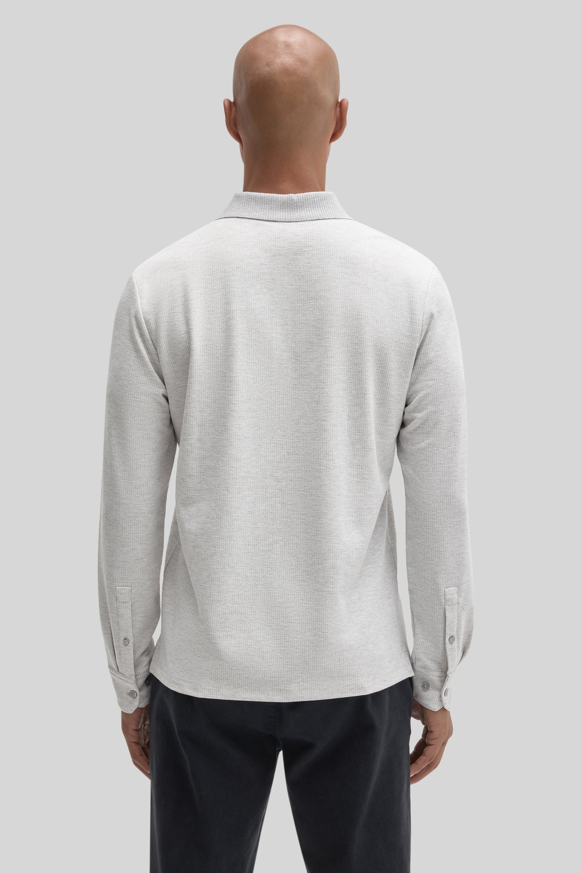 Light gray long-sleeve polo shirt with ribbed collar and button cuffs, shown from back view on model.