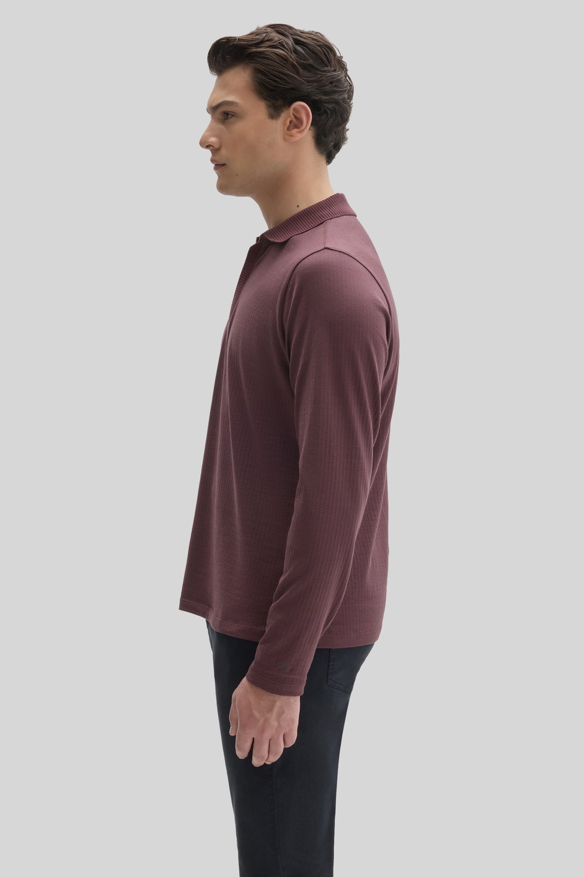 Burgundy long sleeve polo with ribbed collar and zip placket worn with black pants.