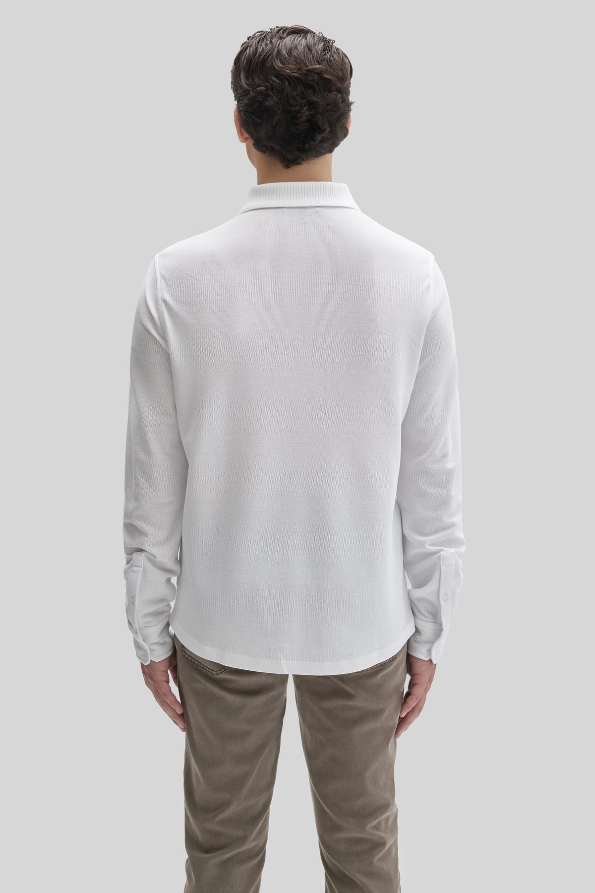 White long-sleeve knit shirt with ribbed collar, worn by model shown from back view.
