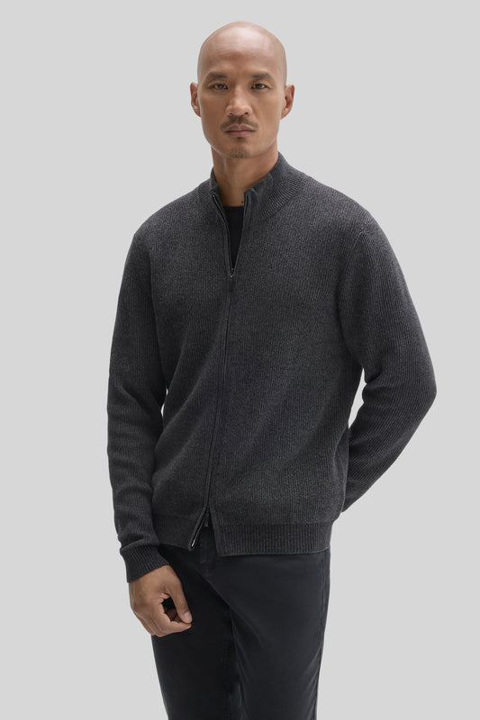 Man wearing charcoal gray ribbed full-zip mock neck sweater with long sleeves over black shirt.