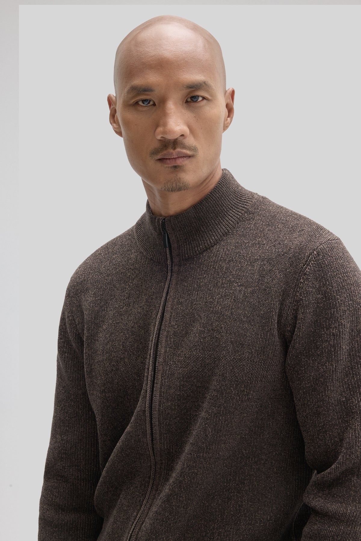 Charcoal gray ribbed mock neck sweater with full zip front worn by a man.