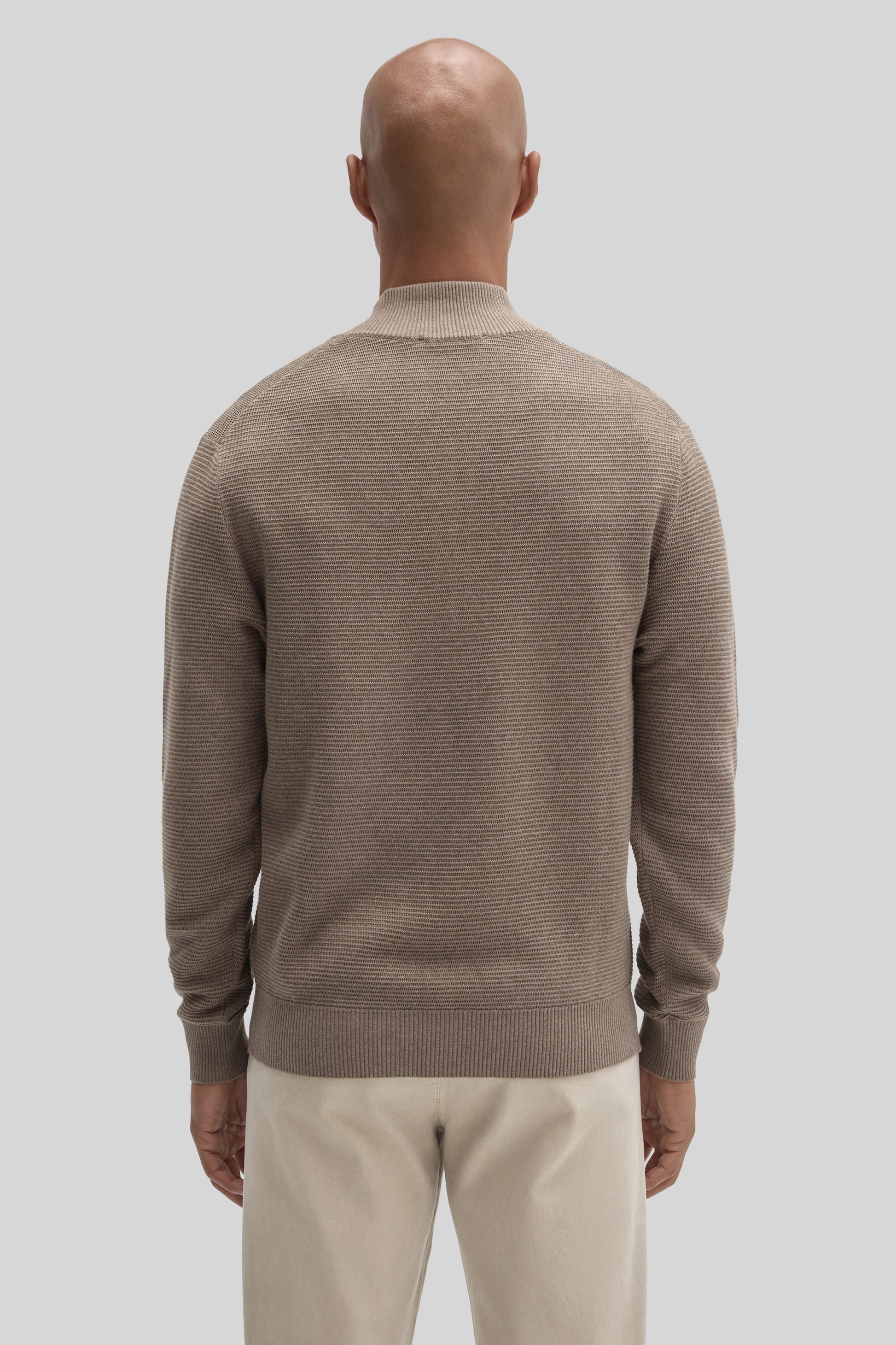 Beige quarter zip sweater with horizontal ribbed texture and ribbed collar, cuffs, and hem.