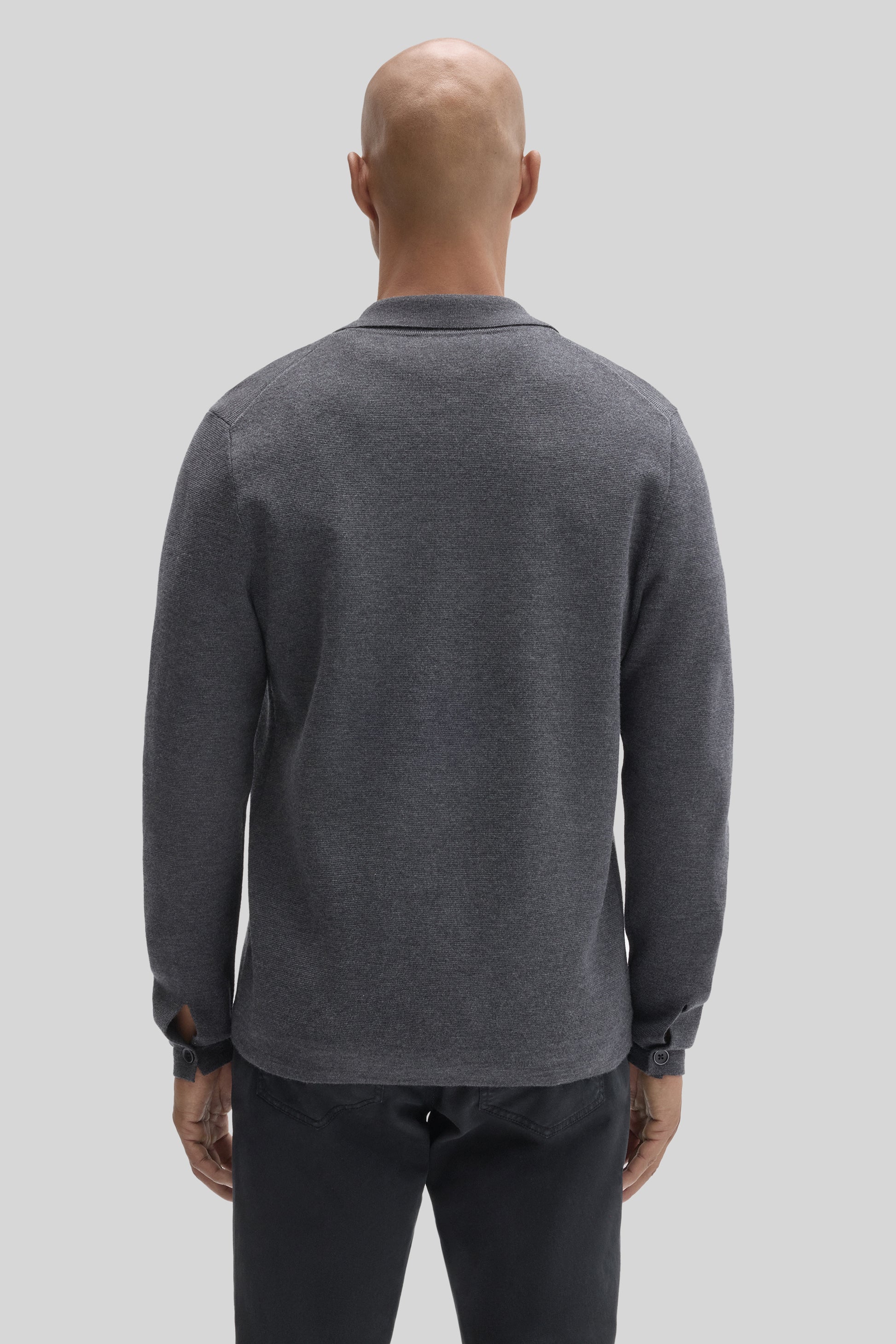Charcoal gray buttoned cardigan with long sleeves and ribbed collar, back view on model.