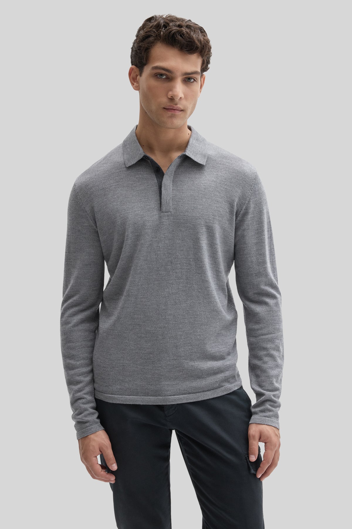 Gray long sleeve sweater polo with collar and button placket, paired with black pants.