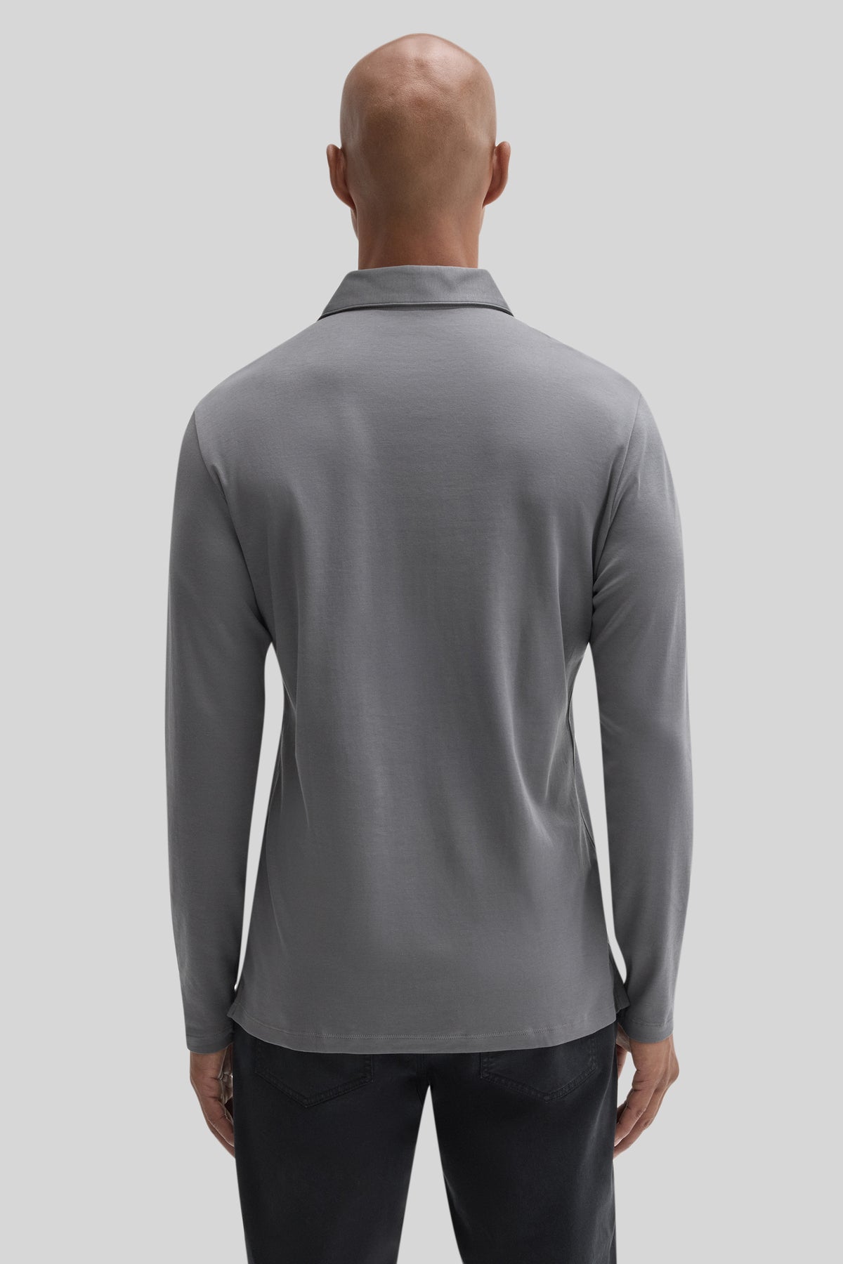 Man wearing gray long sleeve polo shirt with herringbone texture, shown from back view against neutral background.