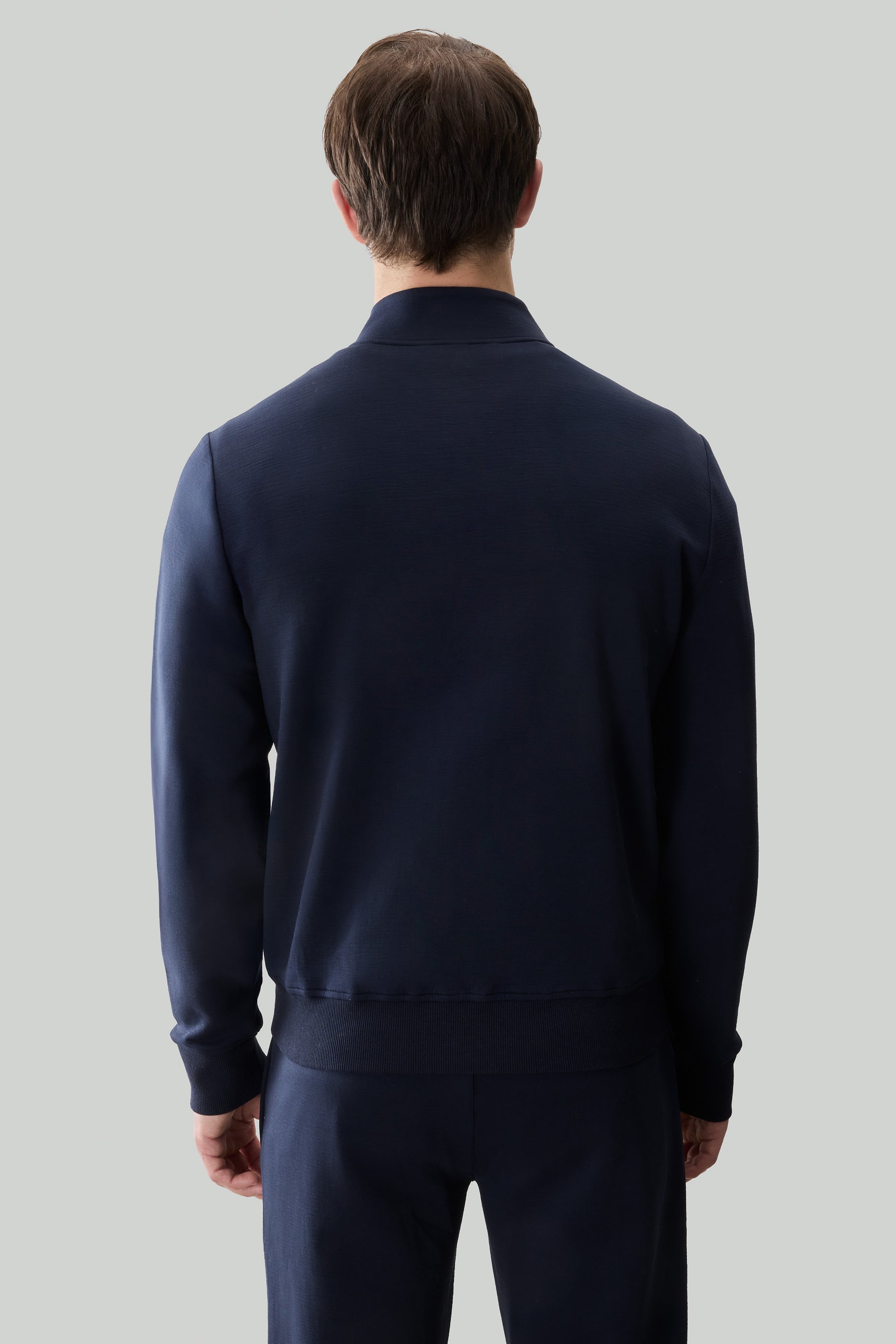 Navy blue long sleeve full zip sweatshirt with ribbed cuffs and collar, shown from back.