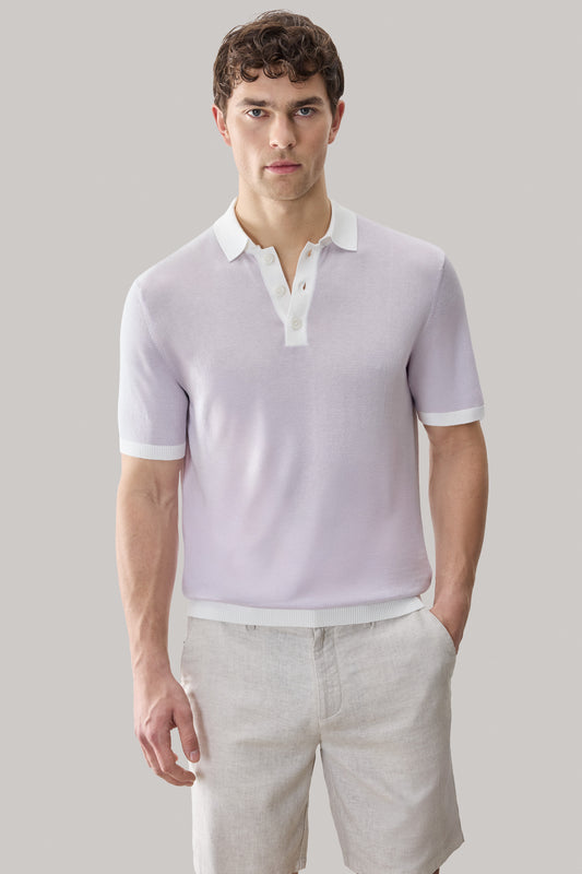 Man wearing light lavender short-sleeve polo sweater with white collar and cuffs, paired with beige shorts.