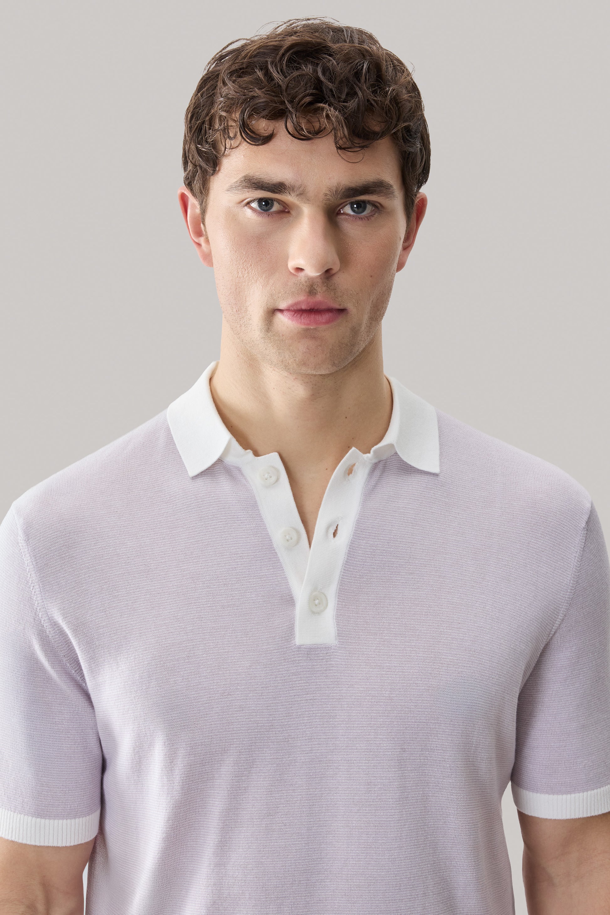 Men's lavender sweater polo with white collar and button placket.