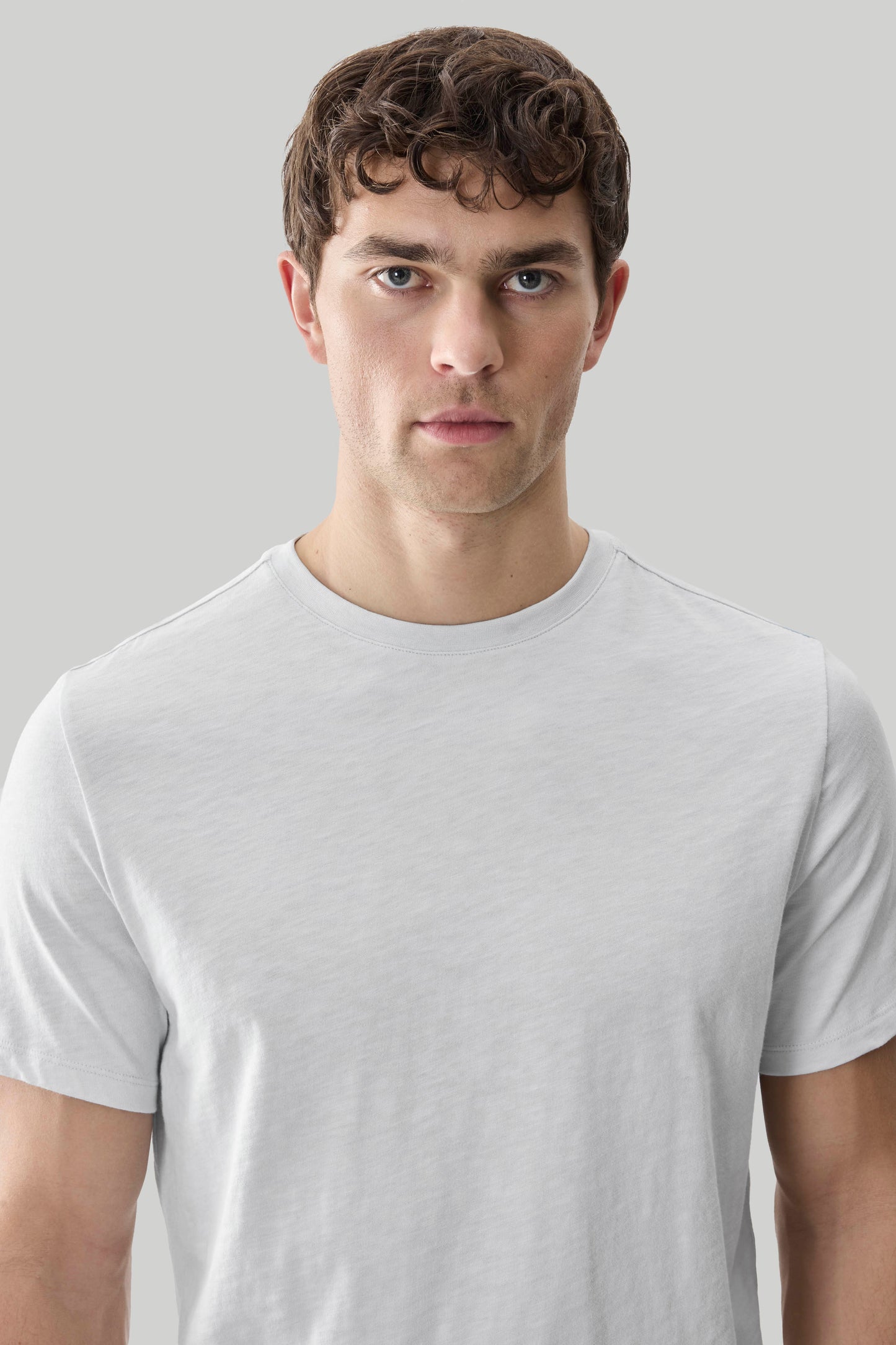 Man wearing light gray short-sleeve crew neck t-shirt with textured slub fabric.
