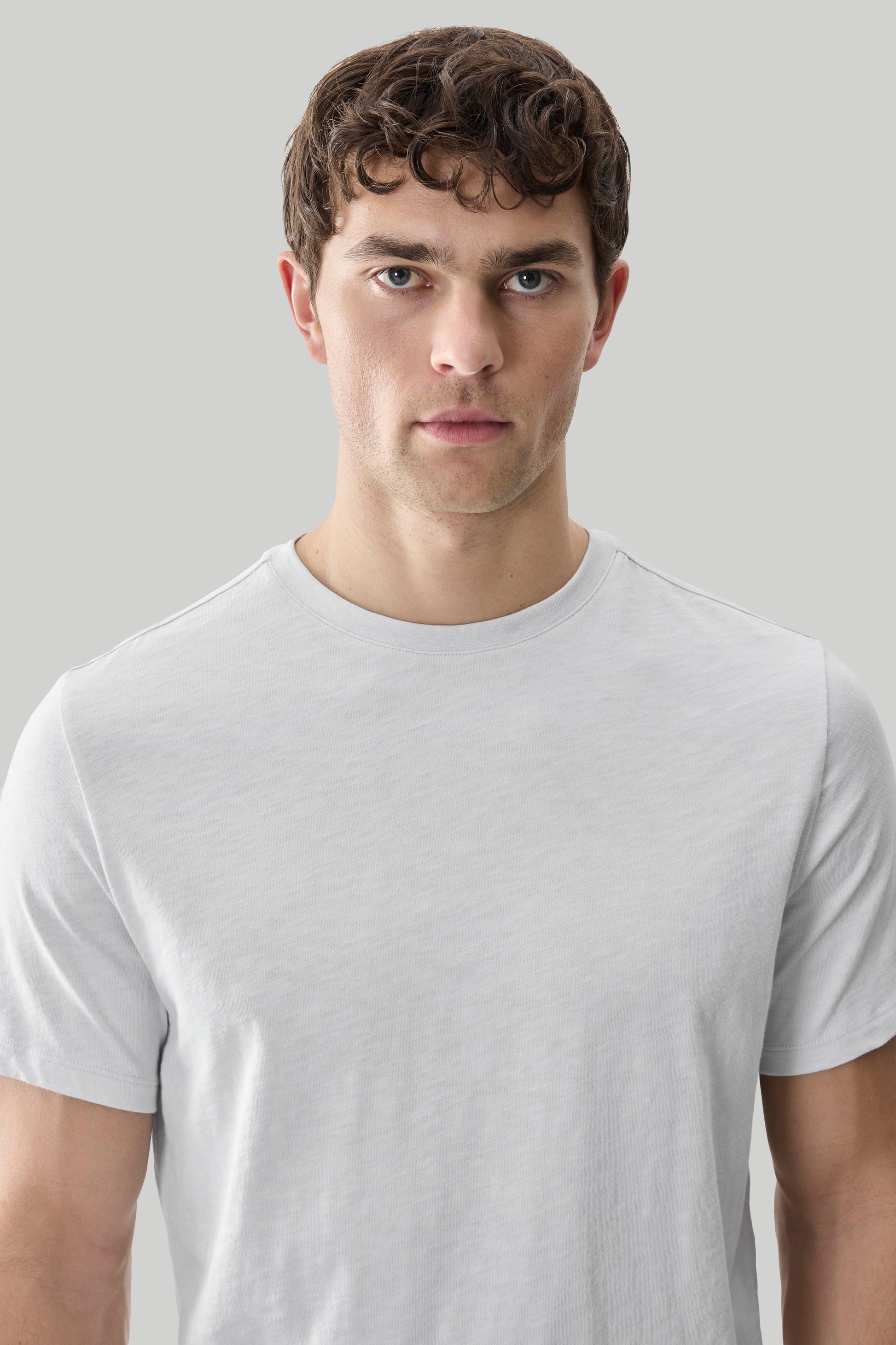 Man wearing light gray short-sleeve crew neck t-shirt with textured slub fabric.