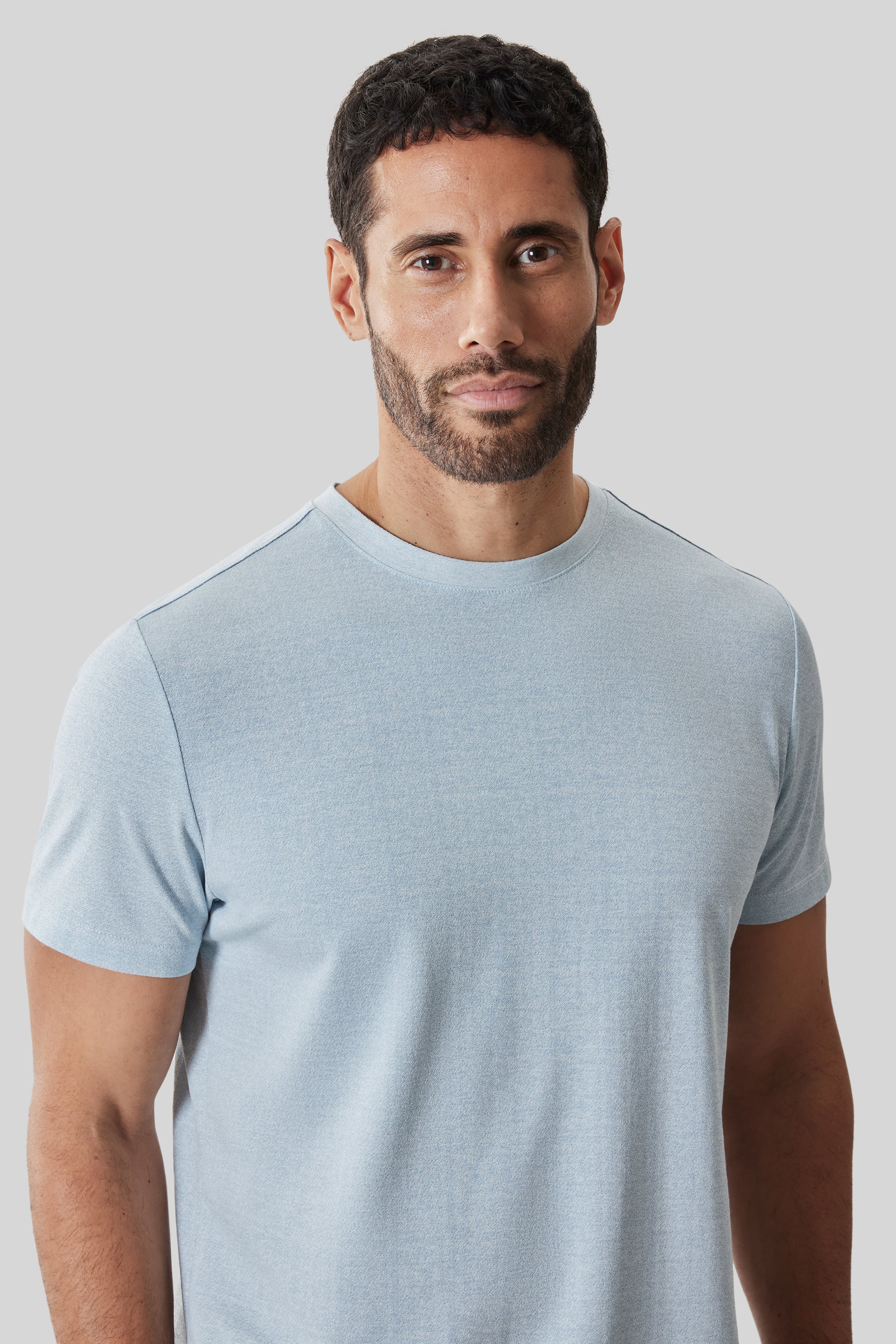 Man wearing light blue short-sleeve crew neck t-shirt with textured fabric.