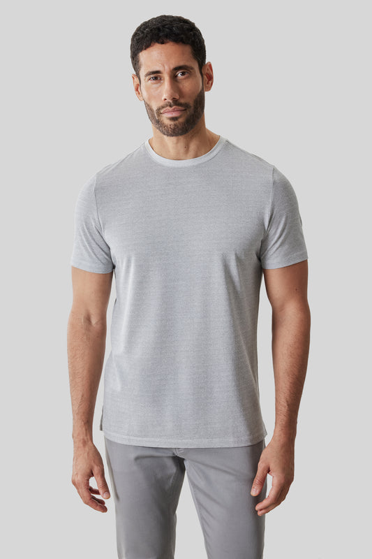 Man wearing light gray short-sleeve crew neck t-shirt with gray pants.