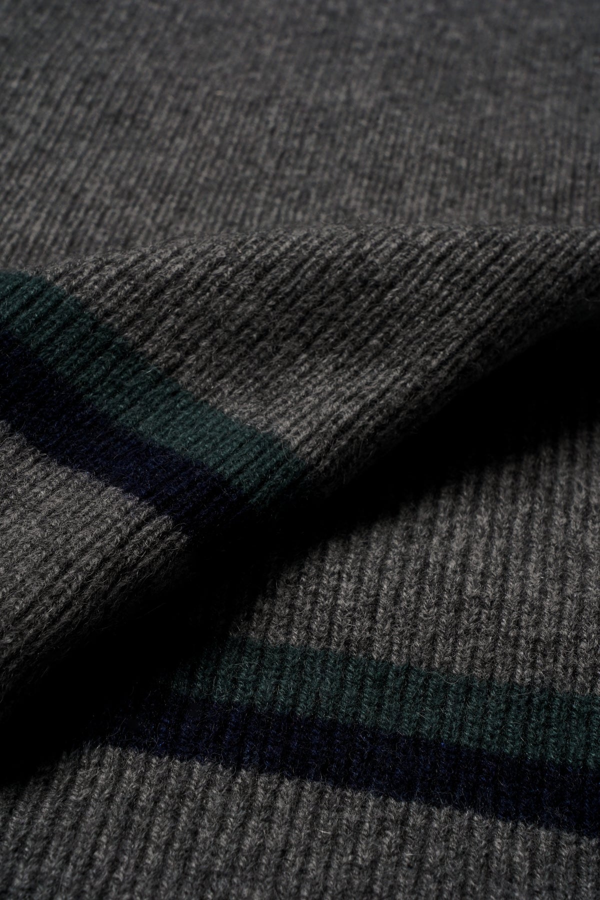 Gray knit scarf with horizontal stripes in dark green and navy blue.