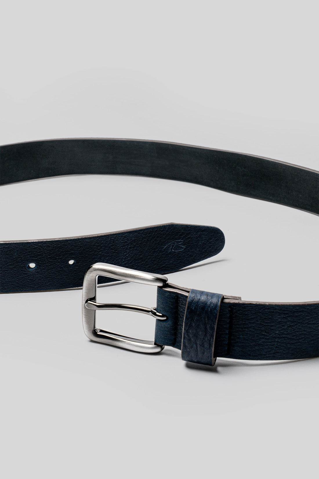 Dark blue leather belt with silver-toned rectangular buckle and single stitch detail.