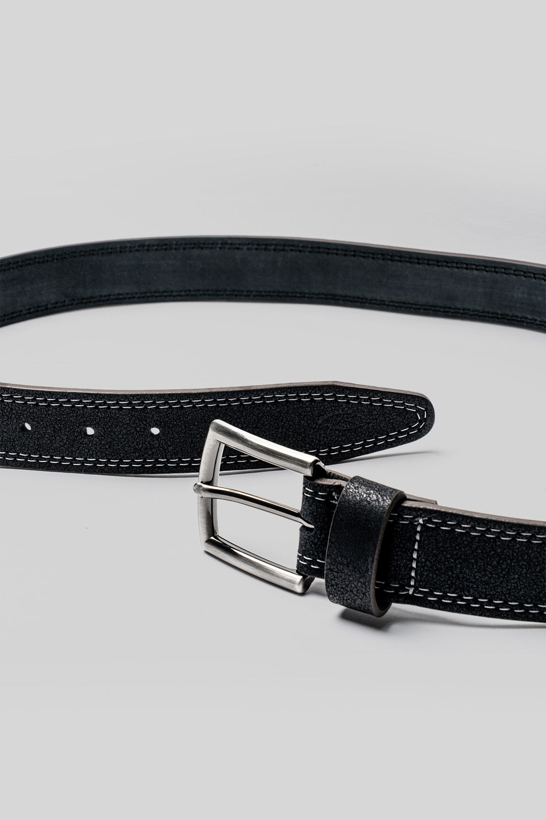 Black leather belt with white contrast stitching, silver rectangular buckle, and evenly spaced punch holes along the length.