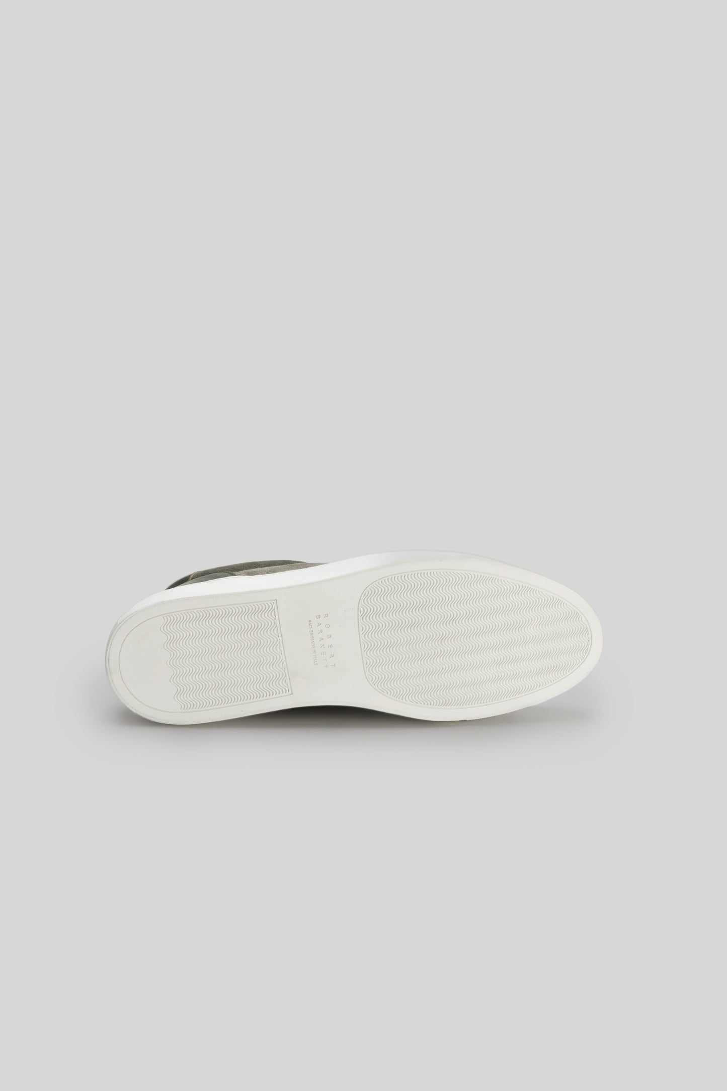 White and gray sneaker sole with textured rubber tread pattern, shown from underneath.