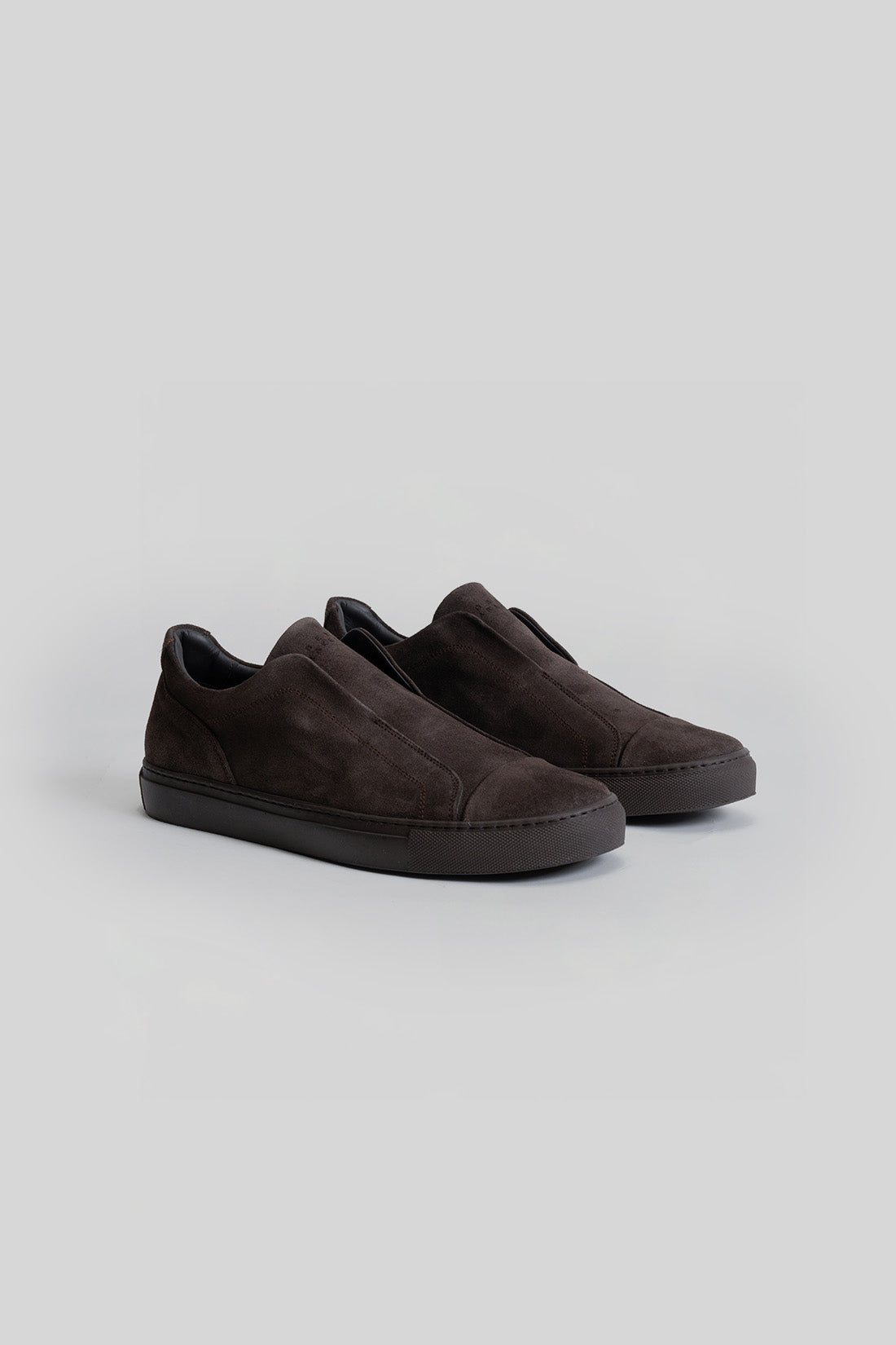 Black suede slip-on sneakers with black rubber sole and padded collar.