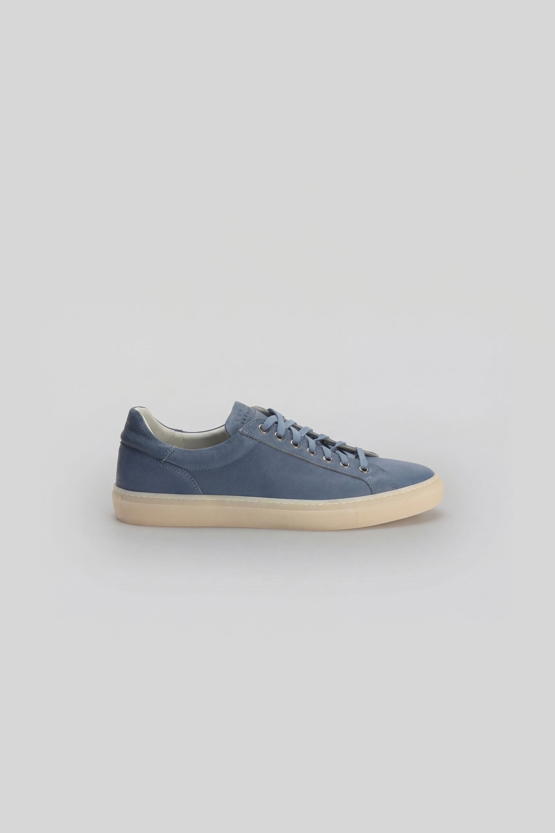 Blue leather sneaker with cream sole and lace-up front closure, shown from the side profile.