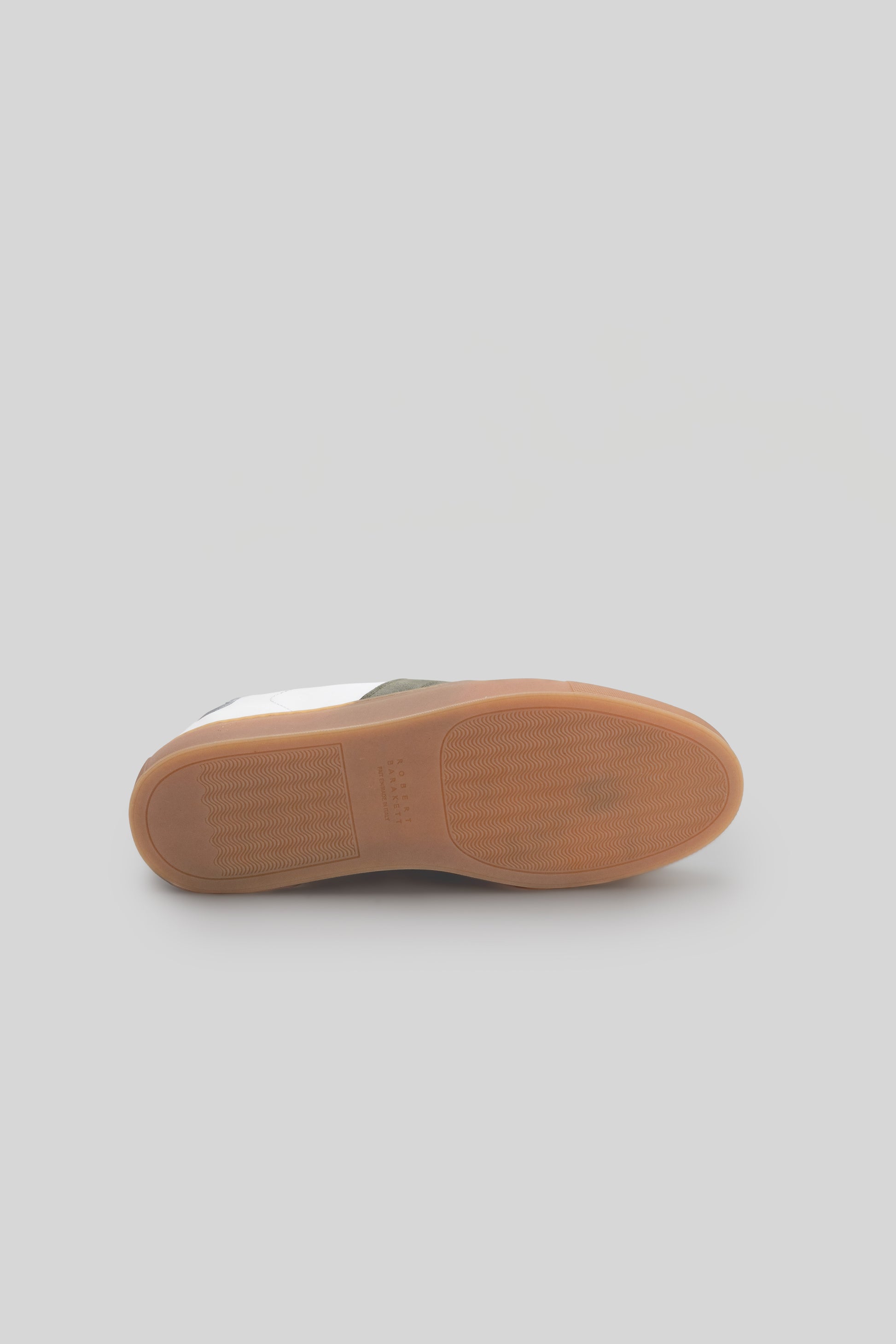 Sole view of white and gray sneaker with tan rubber outsole and textured tread pattern.