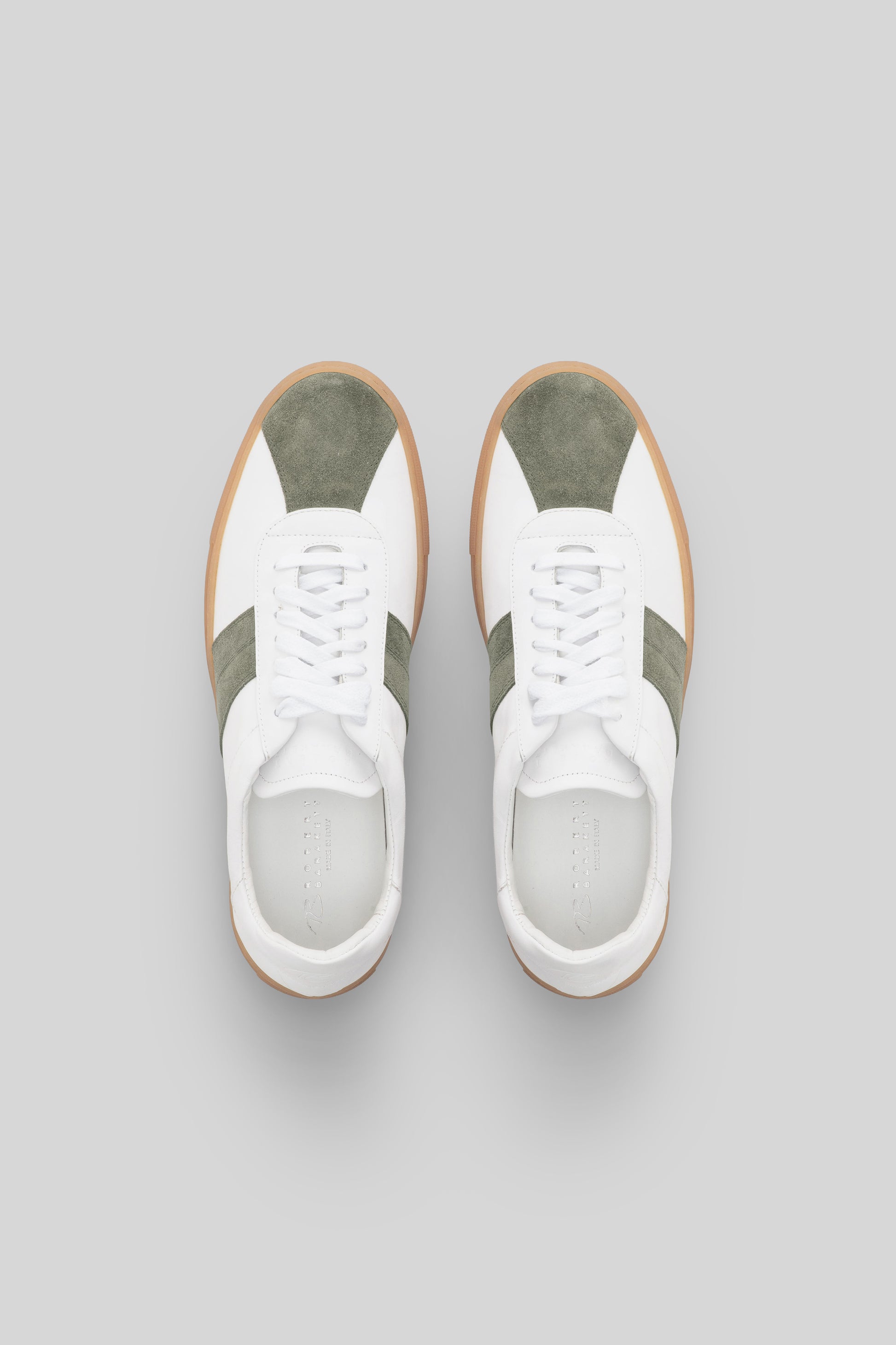 White sneakers with olive green stripes and gum sole, shown from above.