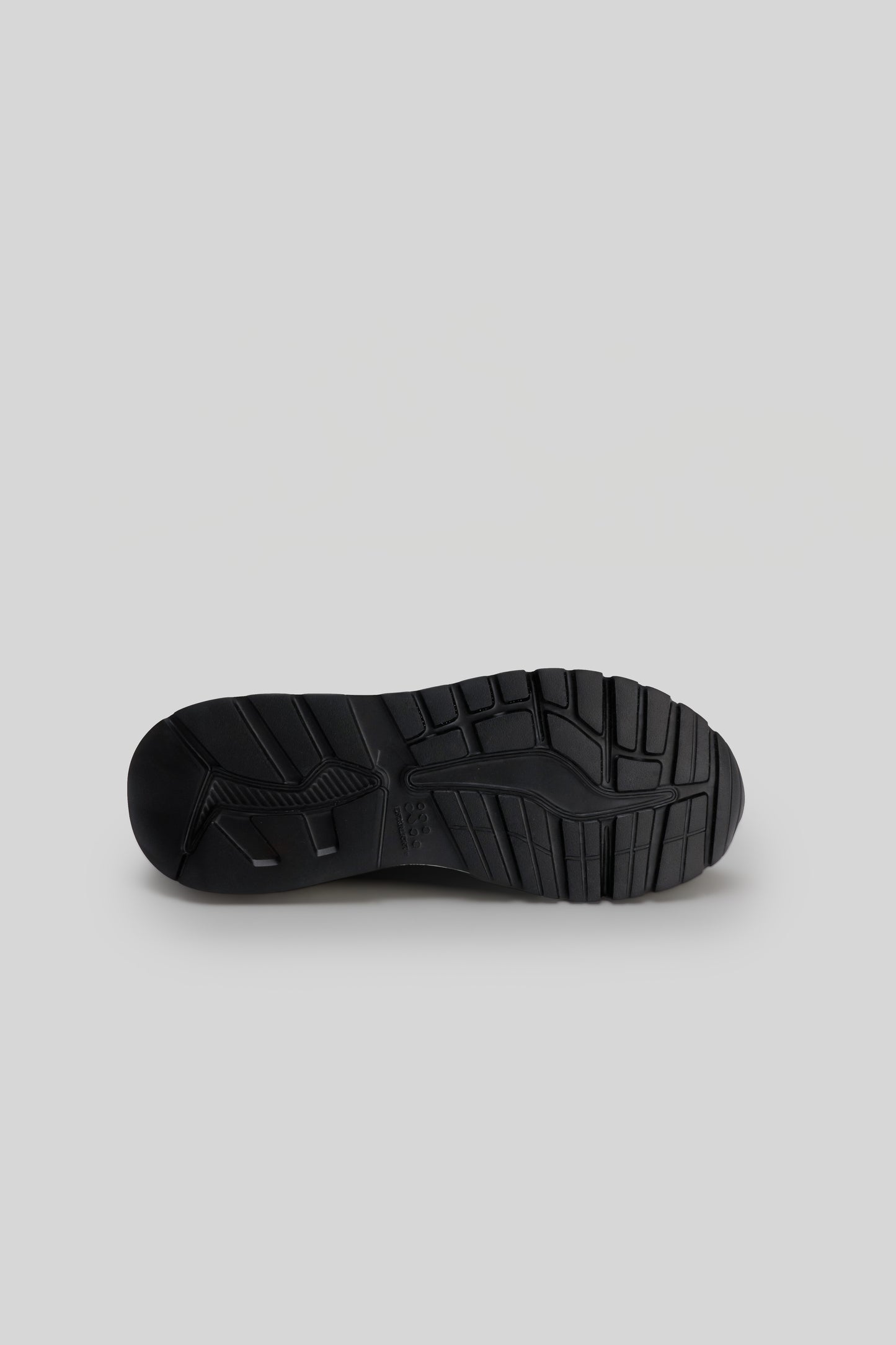 Black knit sneaker sole with textured tread pattern, shown from underside view.