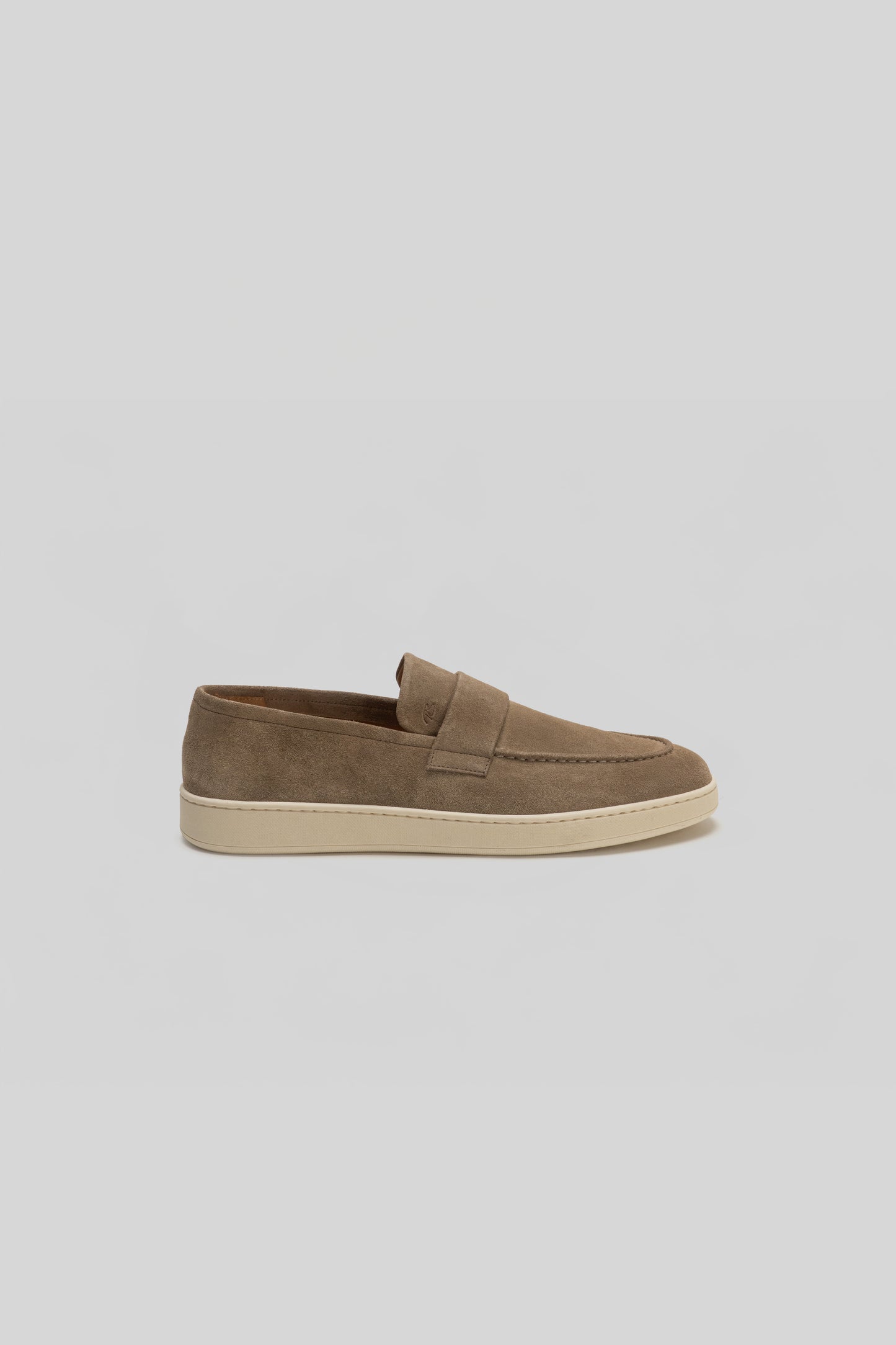 Tan suede loafer with cream rubber sole, viewed from the side.