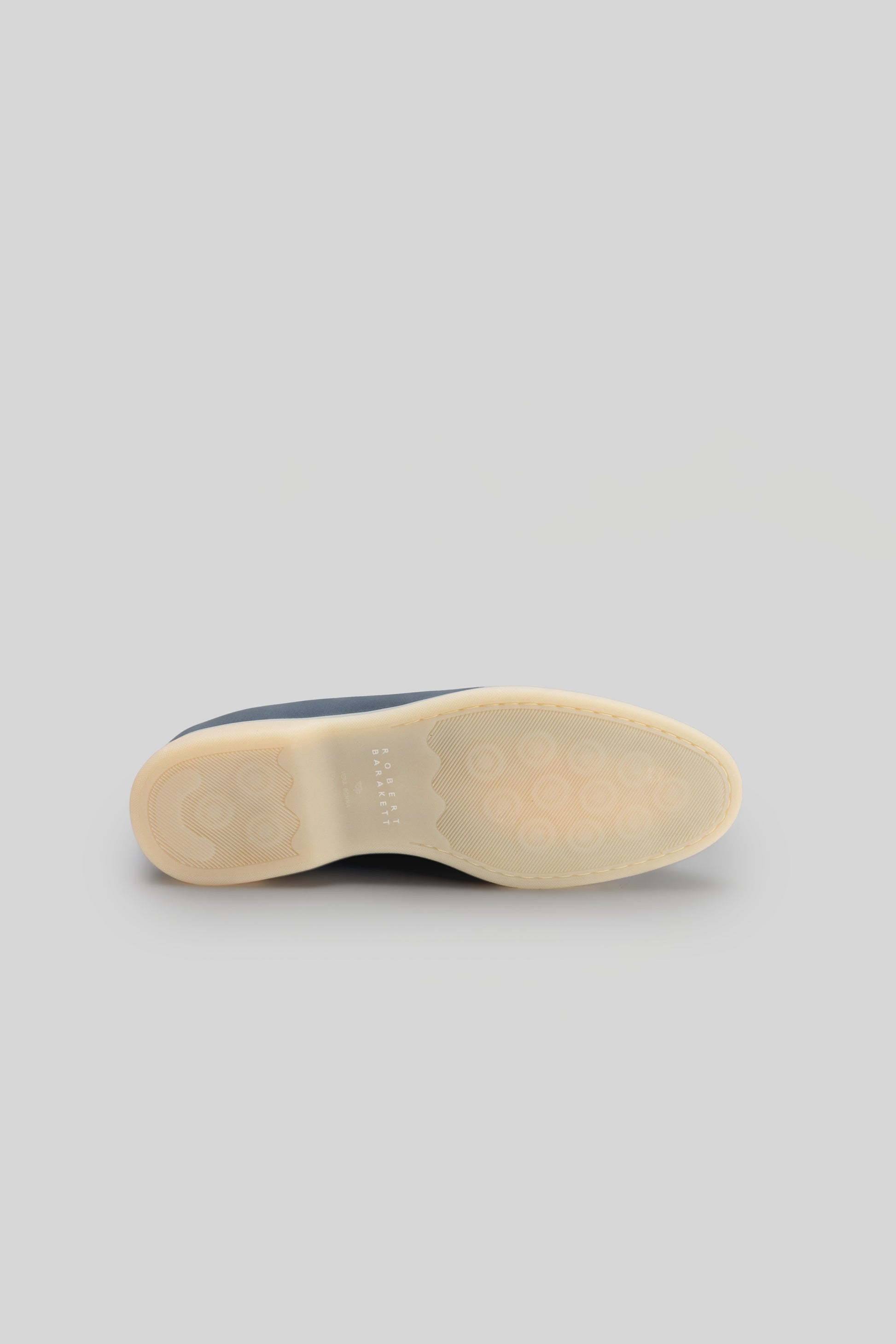 Navy and cream loafer sole with textured rubber tread and light tan inner base.